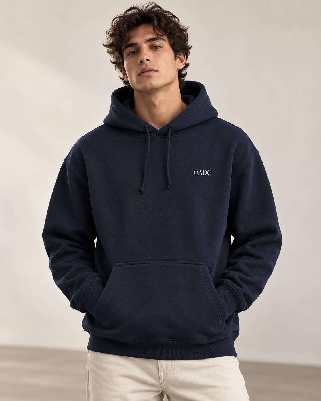 Model wearing a navy OADG hoodie